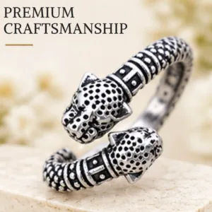 Close-up product image of the classic lion face chitai silver band resting on a textured stone, highlighting its premium craftsmanship and detailed lion heads.