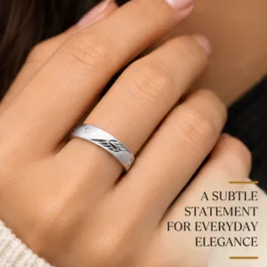Close-up lifestyle portrait of a woman's hand wearing the impressive silver band, featuring text highlighting a subtle statement for everyday elegance.