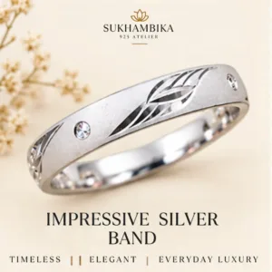 Main promotional product image of the impressive silver band resting on a textured white stone surface, highlighting the text "Timeless | Elegant | Everyday Luxury".