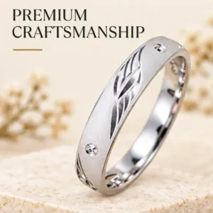 Close-up product image of the impressive silver band resting on a textured surface, highlighting its premium craftsmanship, matte finish, and leaf engraving.