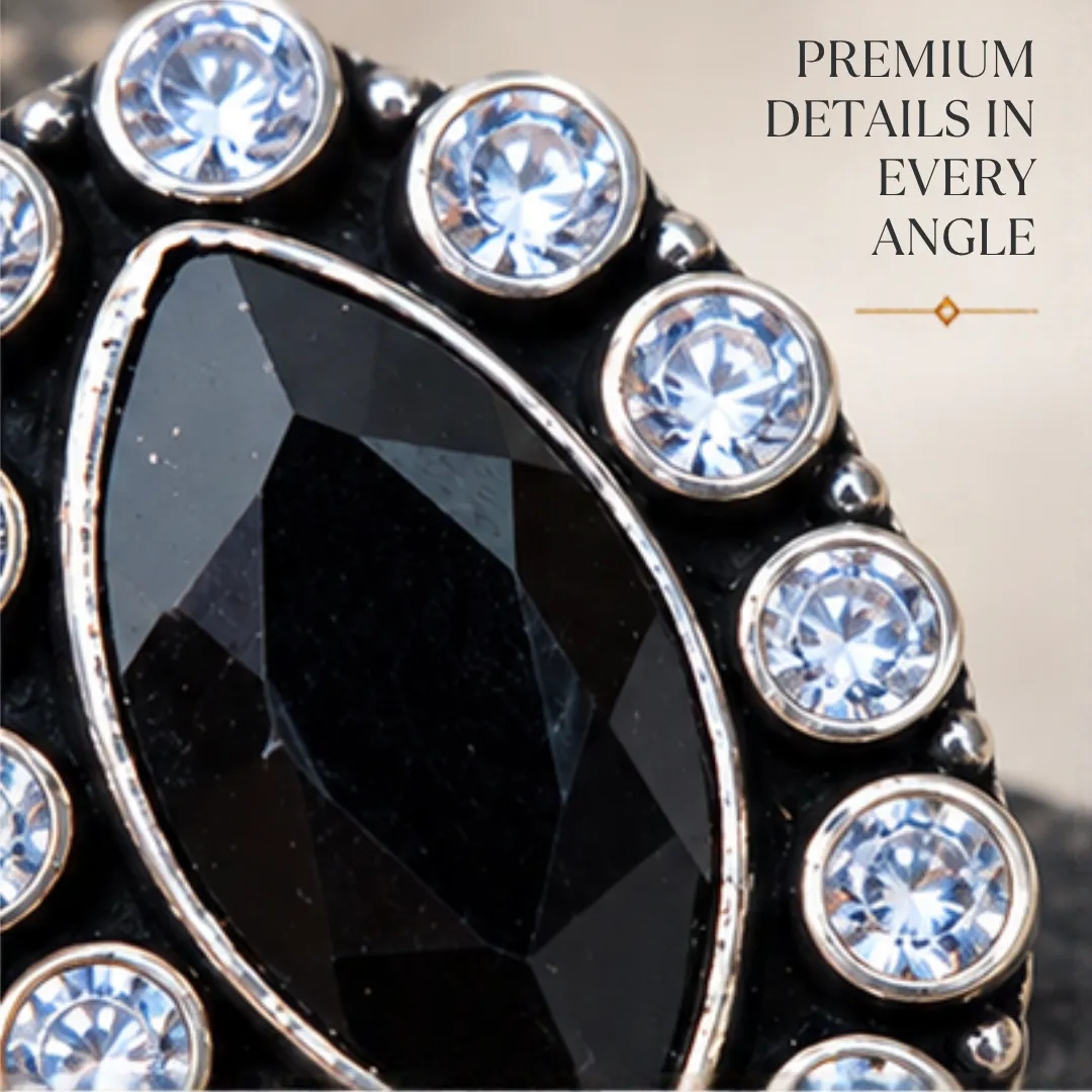 scintillating-center-black-cutstone-jadau-silver-ring-sukhambika (2) Detailed macro graphic of a black cutstone jadau silver ring, highlighting premium details in every angle with a focus on the marquise center stone and clear stone halo.