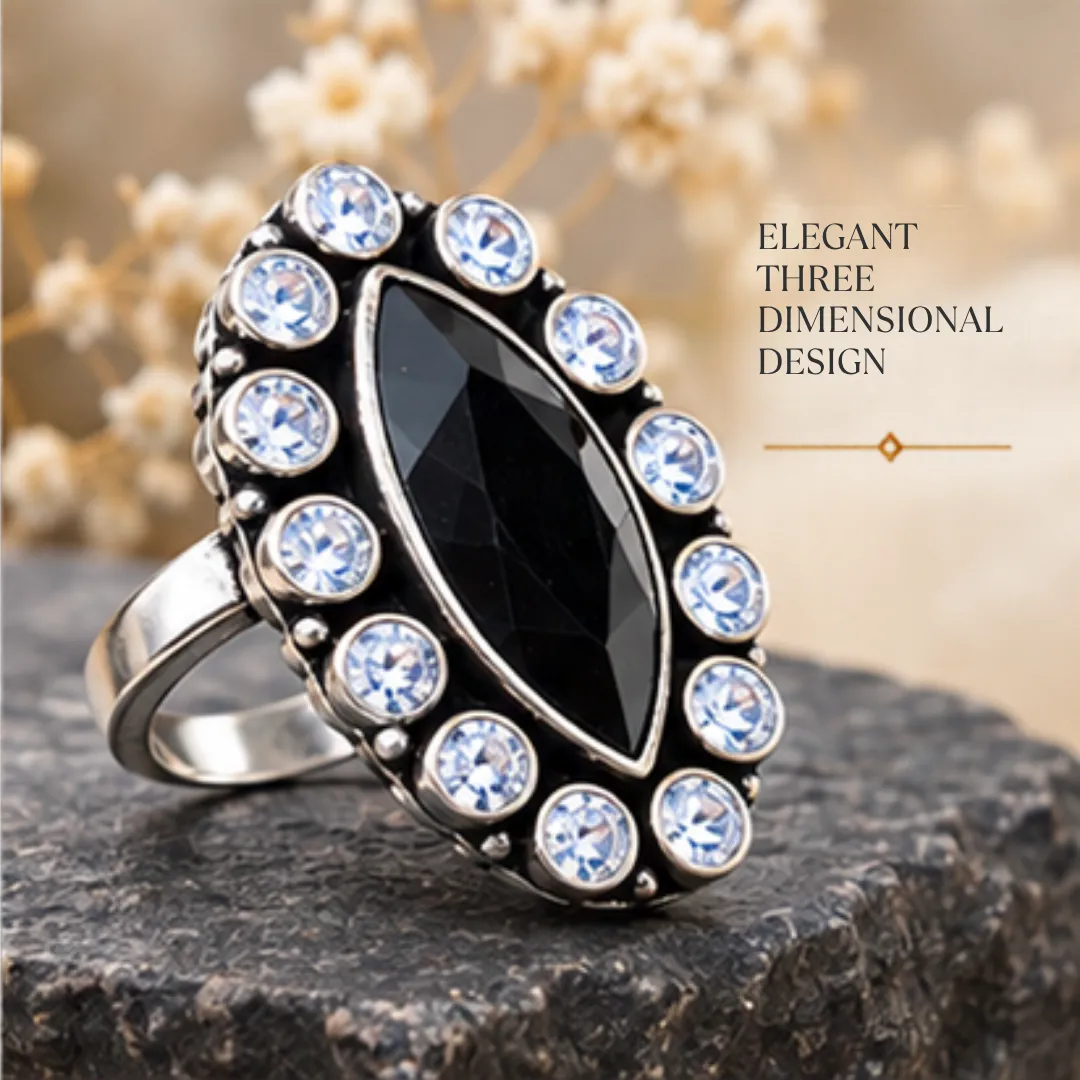 scintillating-center-black-cutstone-jadau-silver-ring-sukhambika (3) Angled product image of the scintillating center black cutstone jadau silver ring resting on a dark stone, featuring text highlighting an elegant three dimensional design.