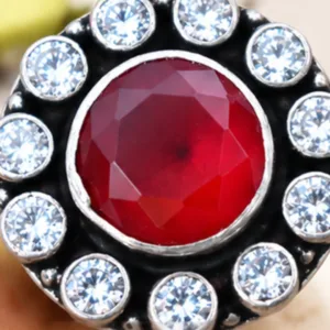 Detailed macro graphic of the ruby jadau silver ring highlighting the stunning ruby cutstone center surrounded by sparkling white stones in an oxidised setting.
