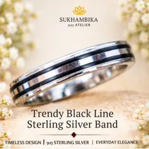 Promotional product image of the trendy black line sterling silver band resting on a textured light surface, highlighting its timeless design, 925 sterling silver purity, and everyday elegance.